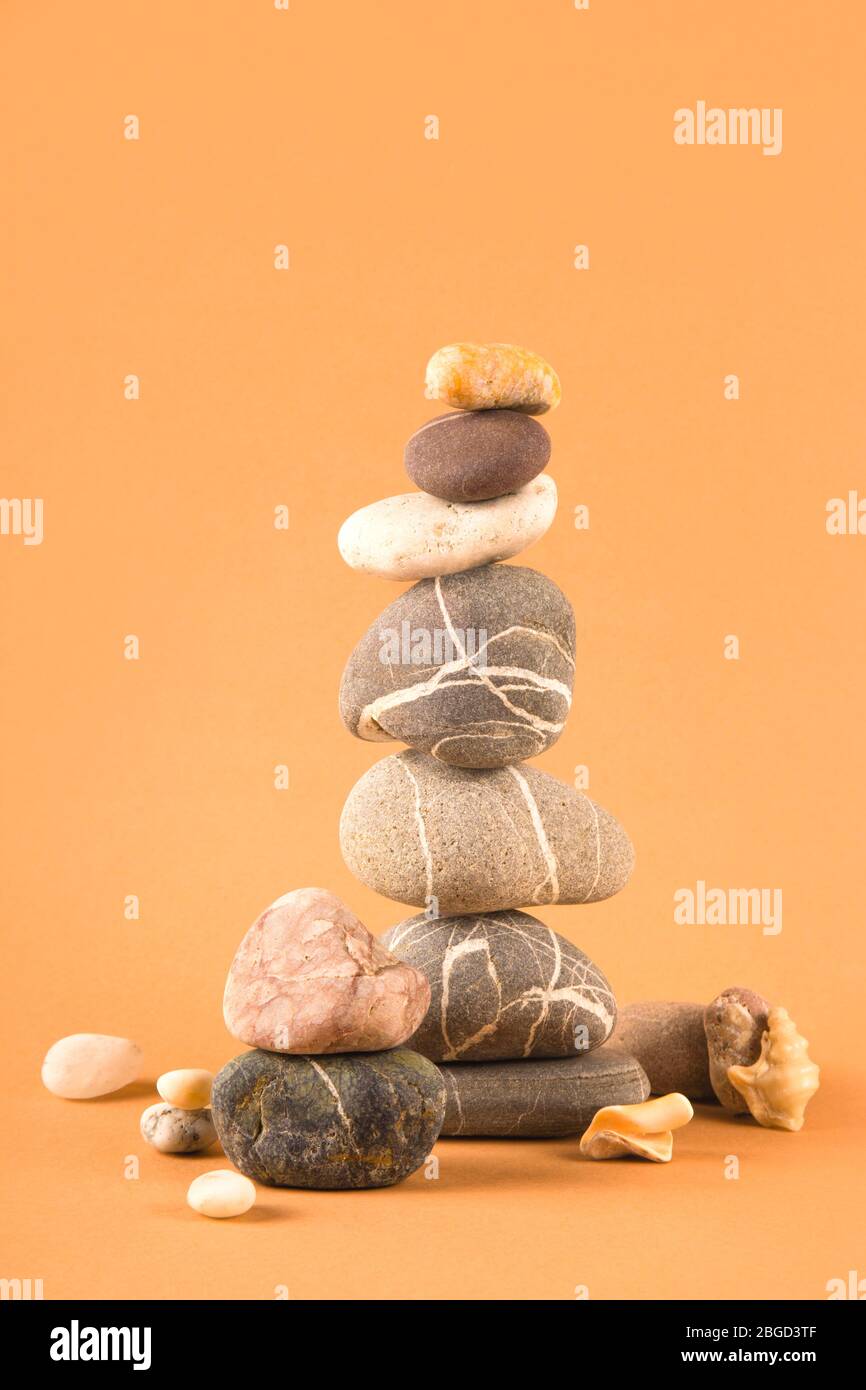 Tower of sea natural stones on a brown background. Stock Photo