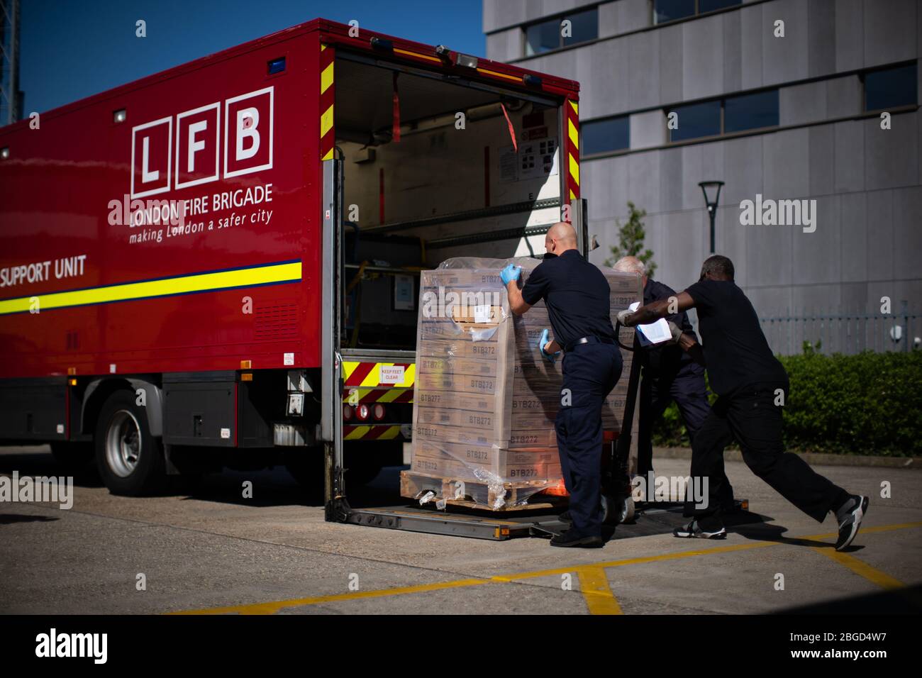 Staff from the London Fire Brigade load PPE at a location in south ...