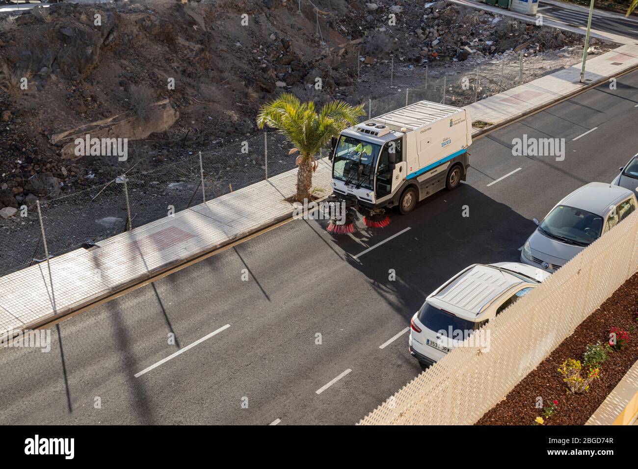 Street sweeper machine cleaning the streets during the covid 19 pandemic, Playa San Juan, Tenerife, Canary Islands, Spain Stock Photo