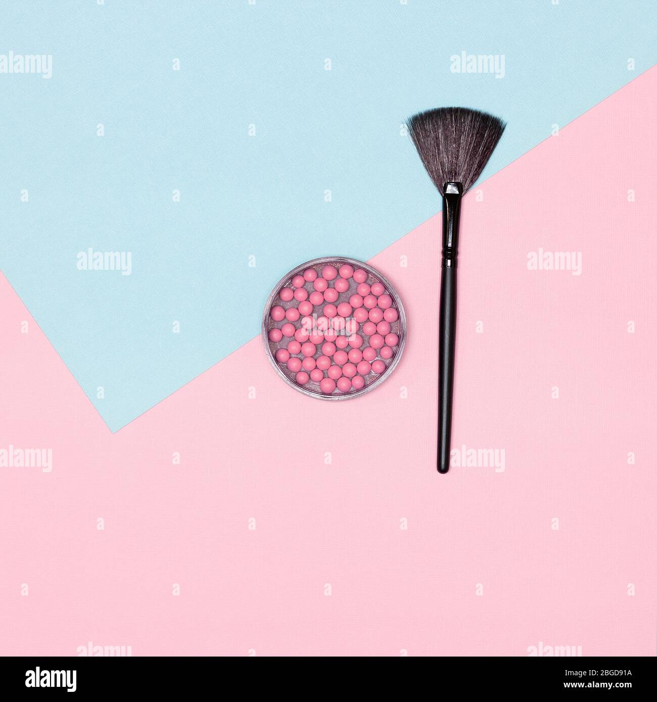 Makeup blush with make-up brush flatlay on pink and blue pastel background Stock Photo