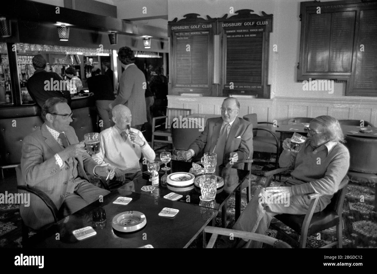 Golf Club bar 1981. Middle England, Middle Class, Middle Age 1980s UK. In the lounge bar a group of men sitting around smoking and chatting and drinking beer. HOMER SYKES Stock Photo