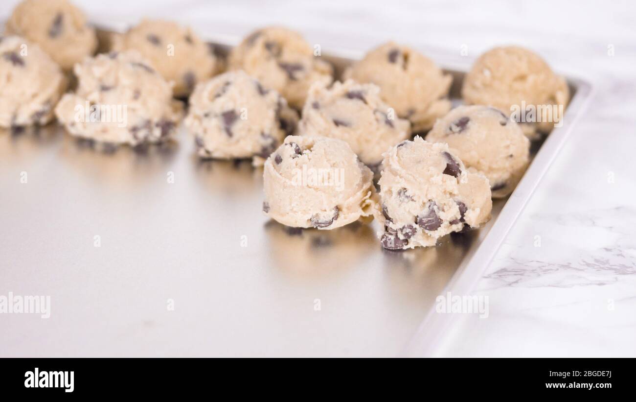 Step by step. Scooping homemade chocolate chip cookies with metal dough