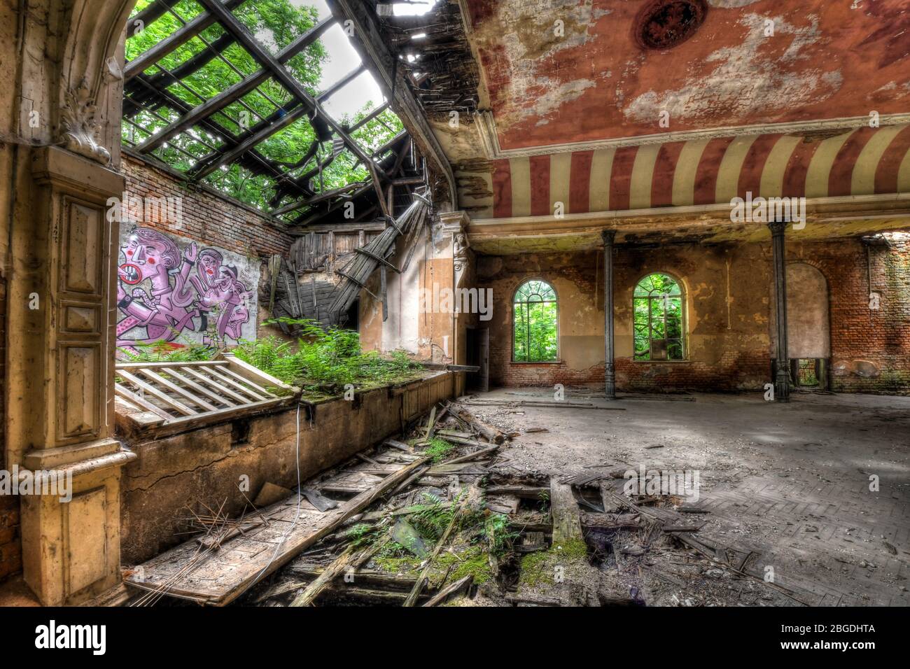 Abandoned Ball Room with pink and white stripes where nature has taken over Stock Photo
