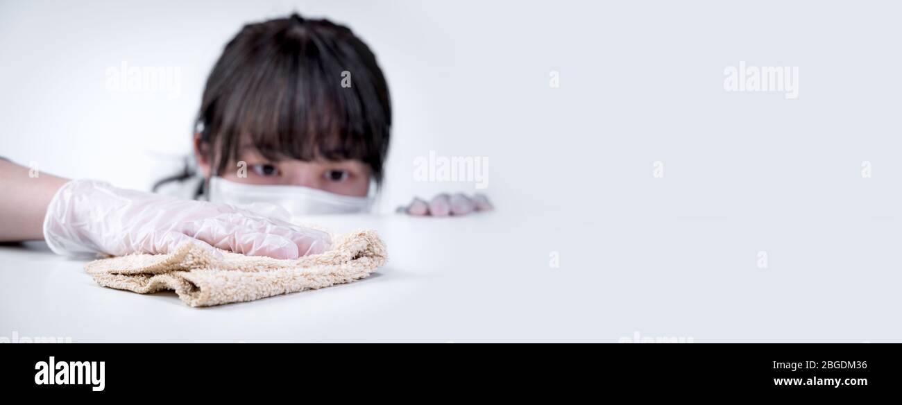 Young woman housewife is cleaning, wiping down home table surface to ...