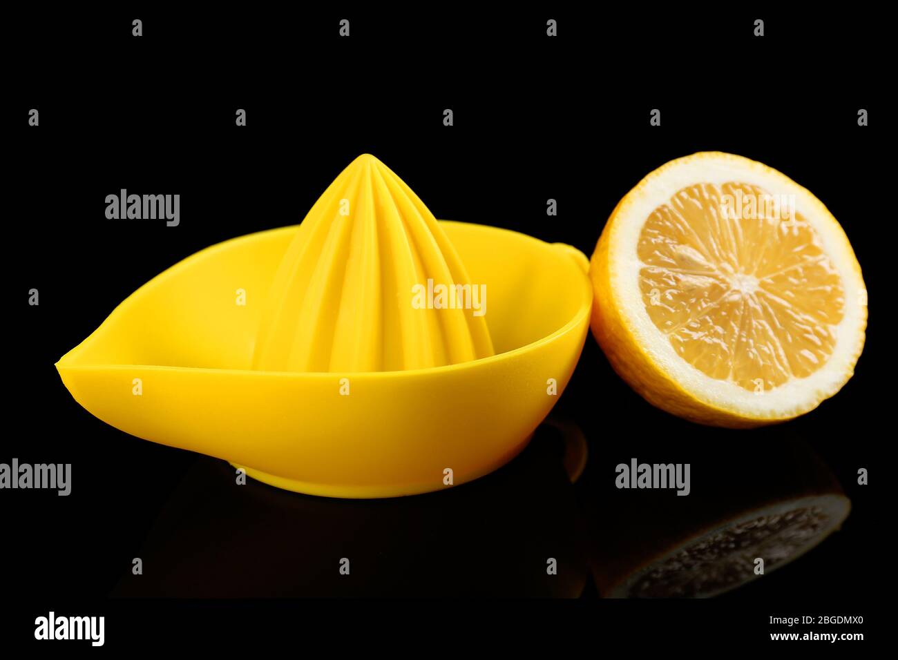 Citrus squeezer with lemon on black background Stock Photo Alamy