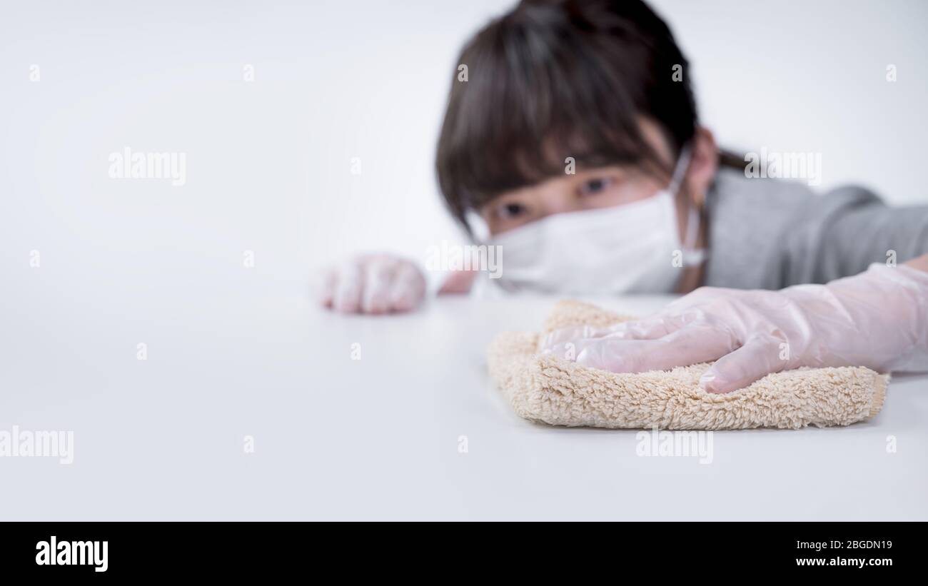 Young woman housewife is cleaning, wiping down home table surface to ...