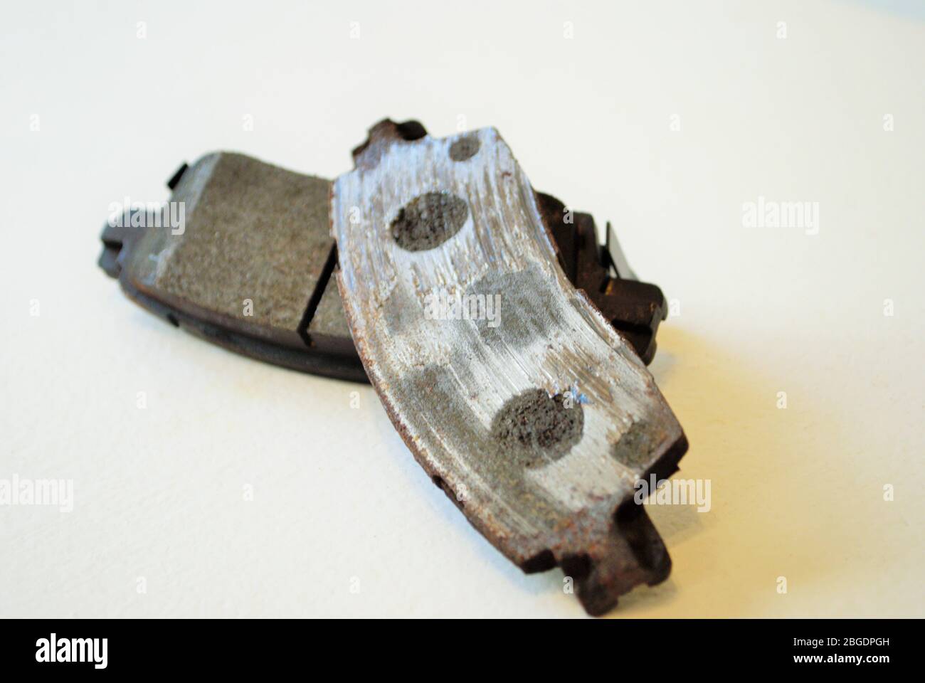 Worn out ruined disc brake pad compared to one that is new Stock Photo