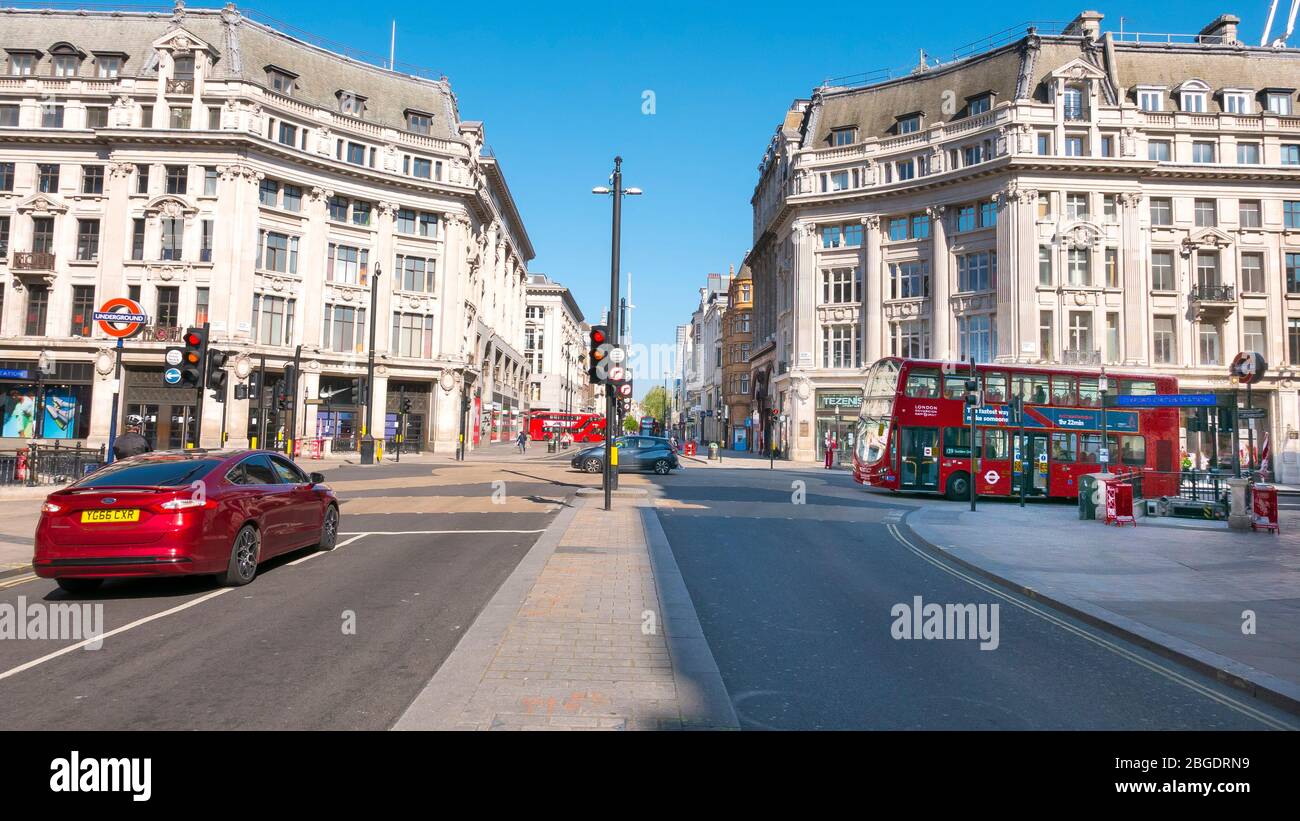 Coronavirus Pandemic a view  of Oxford Circus in London  April 2020. No people only a few buses in the streets, all shops closed for Lockdown. Stock Photo