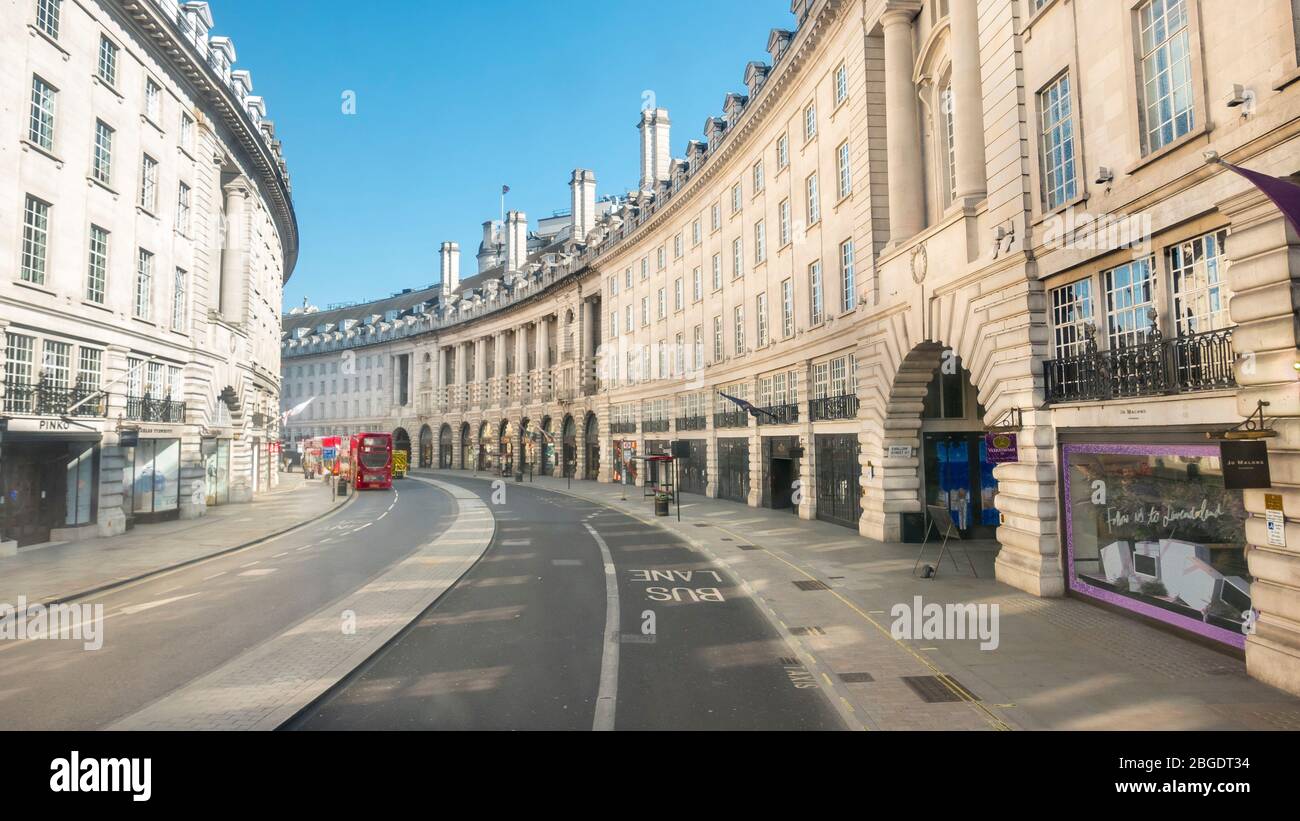 Coronavirus Pandemic. Regent Street in London  April 2020. No people only a few buses  in the streets, all shops closed for Lockdown. Stock Photo