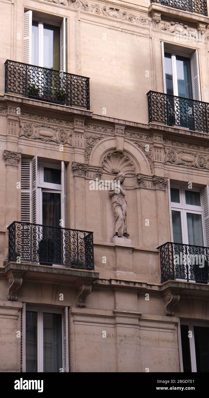 Statue of Dressed Venus at Side of Building Stock Photo