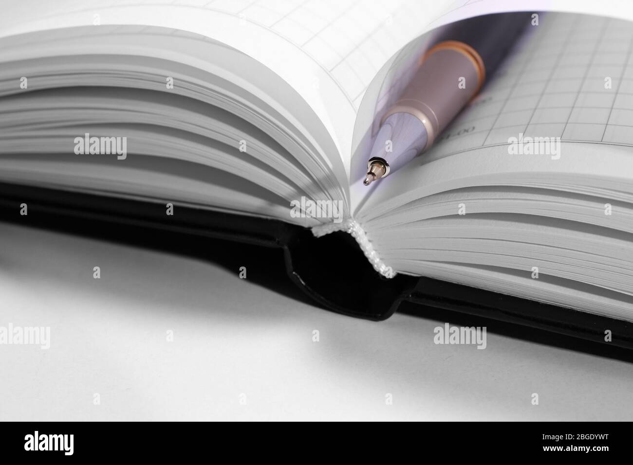 Pen on opened book, close up Stock Photo - Alamy