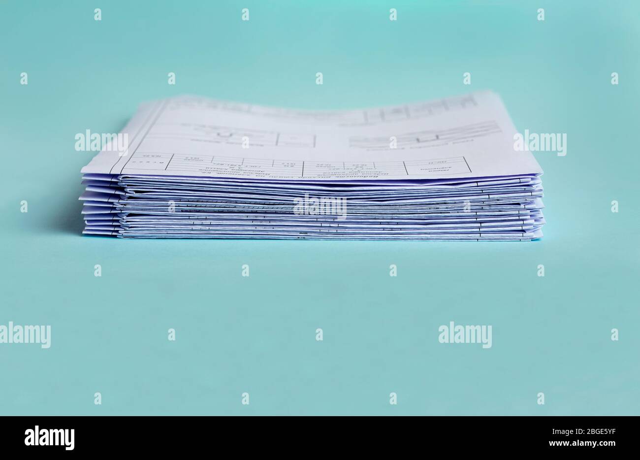 Stack Folding drawings on a blue background. Copy space. Stock Photo