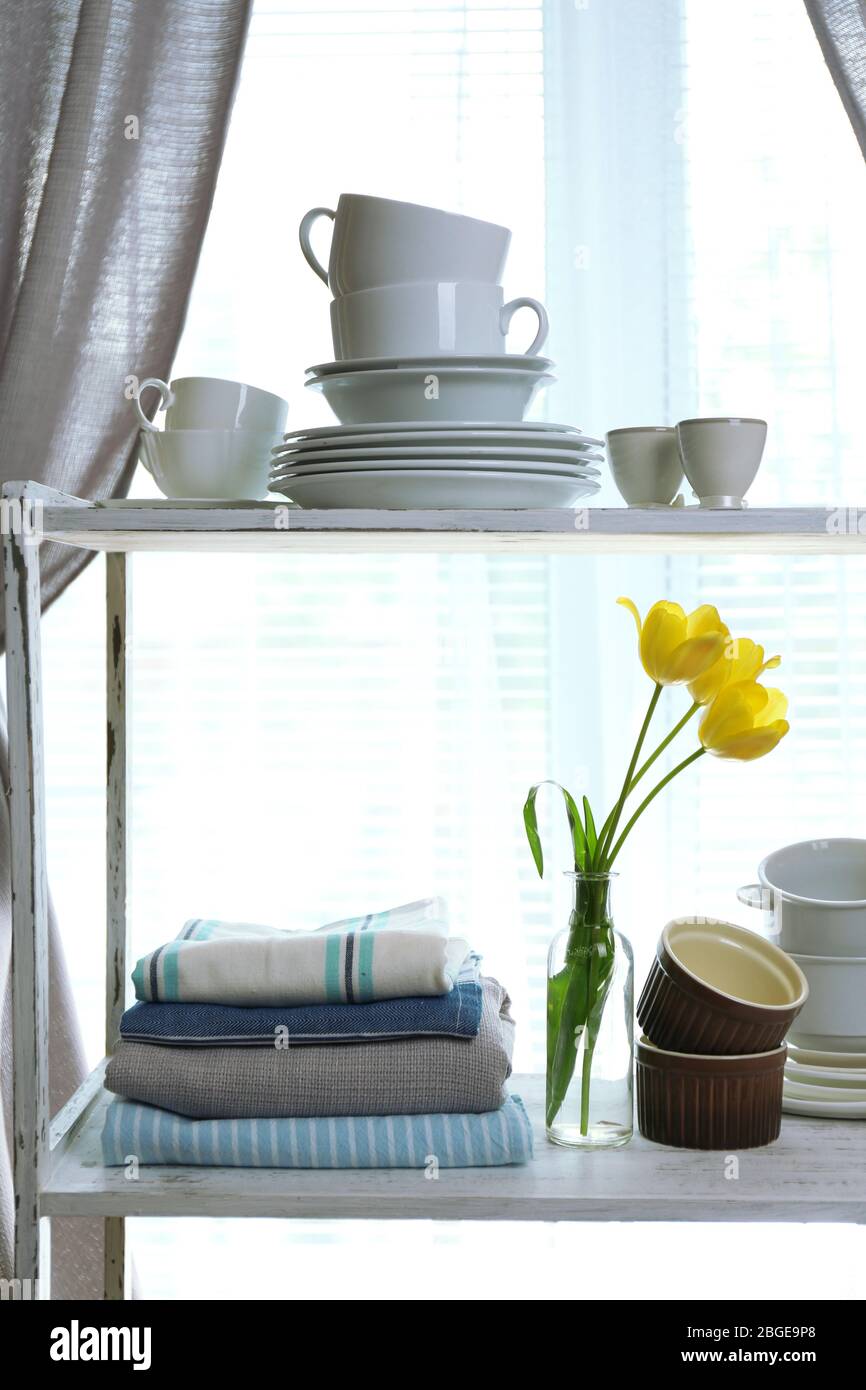 Different tableware on shelf in the interior Stock Photo