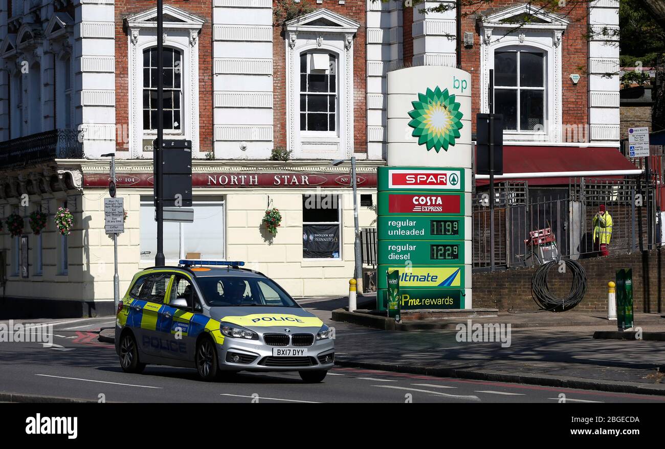 London, UK. 21st Apr, 2020. A police car drives past a petrol station in London, Britain on April 21, 2020. Brent crude plummeted to 22 U.S. dollars a barrel at one point Tuesday morning as global oil demand collapses because of lockdown in many countries to tackle the coronavirus pandemic. Credit: Han Yan/Xinhua/Alamy Live News Stock Photo
