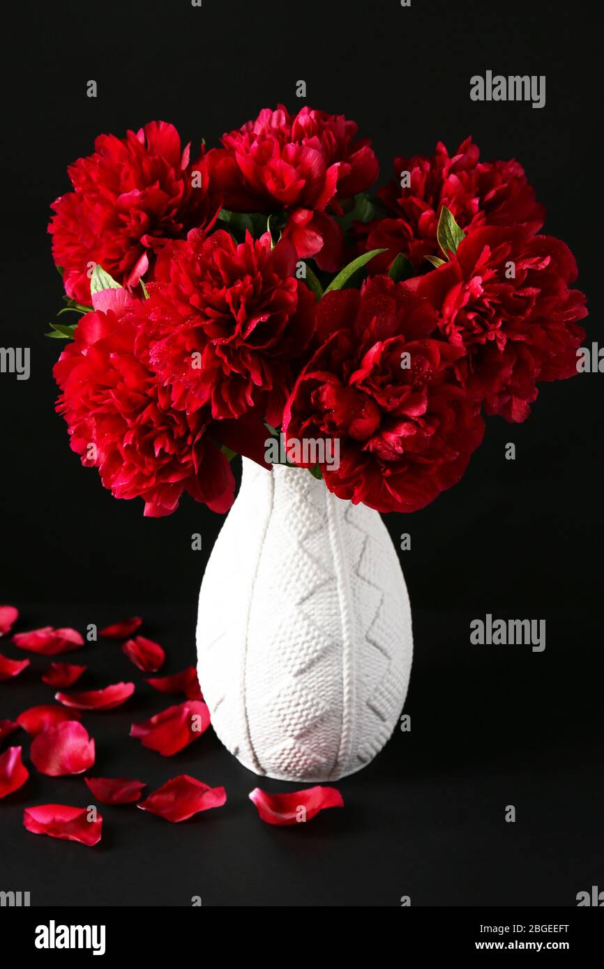 Beautiful pink peonies in vase, on dark background Stock Photo Alamy