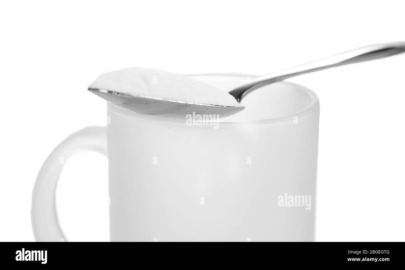 Spoon of baking soda over glass of water, isolated on white Stock Photo
