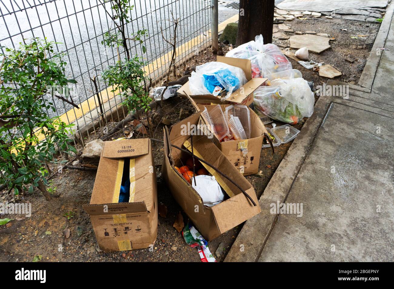 Mountain of garbage and cardboard boxes on the street. The problem of
