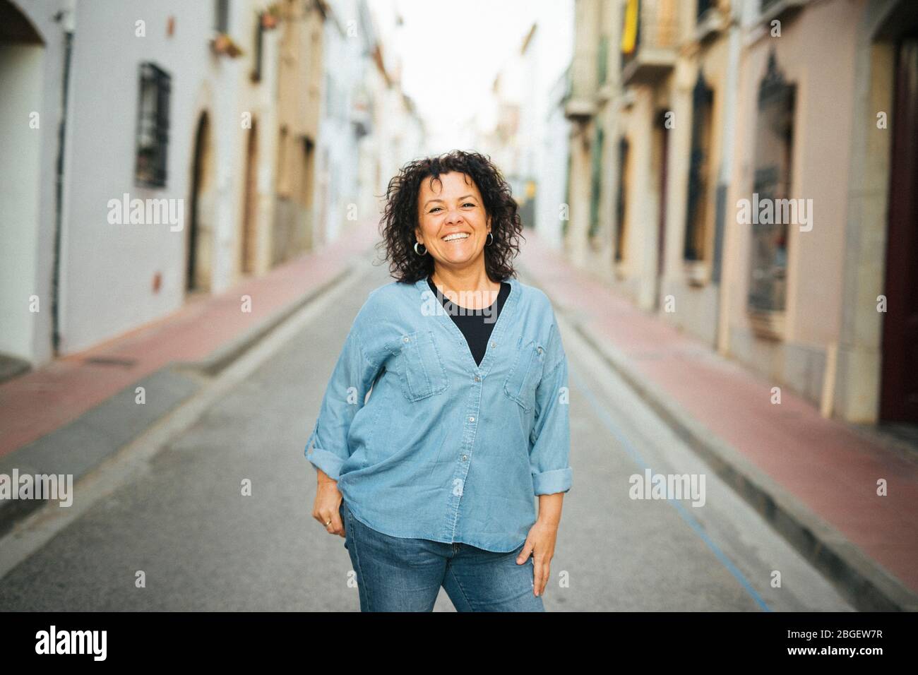 Portrait of a middle-aged smiling woman  on the street Stock Photo