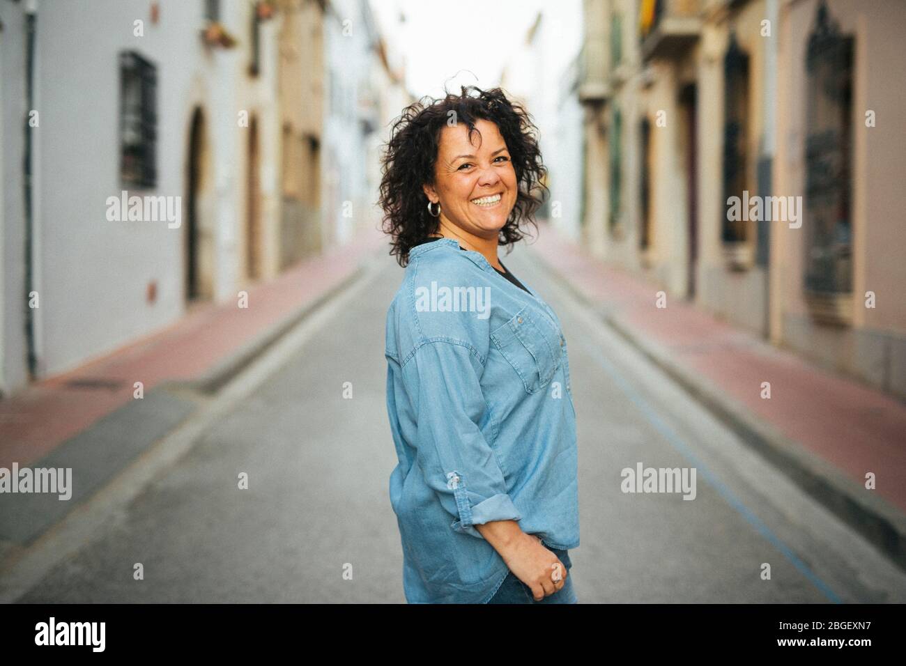 Portrait of a middle-aged smiling woman  on the street Stock Photo