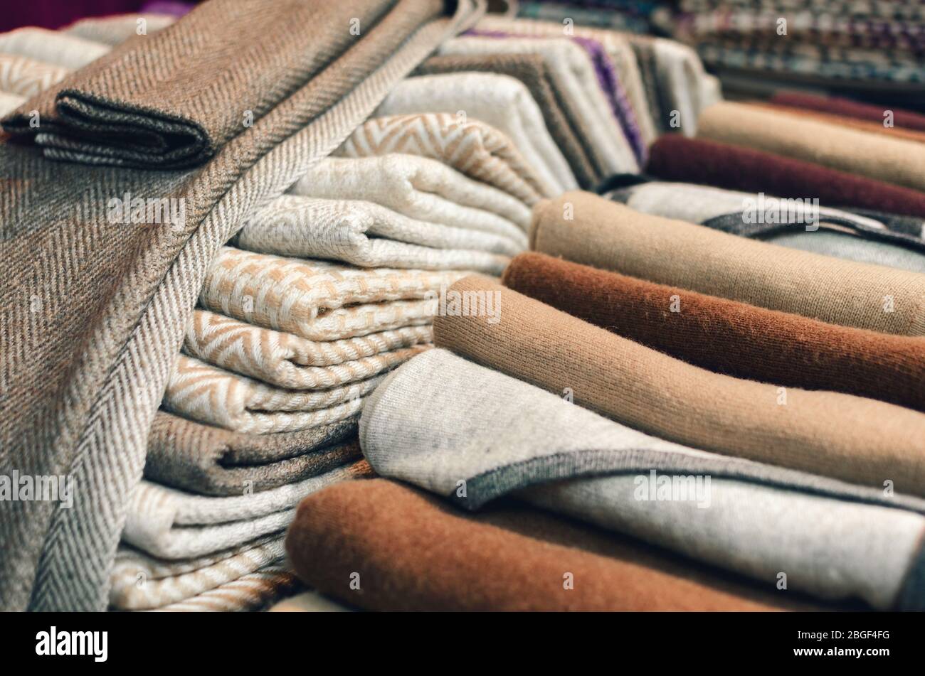 Cashmere wool scarves and wraps with lines and square decoration on a market stall Stock Photo