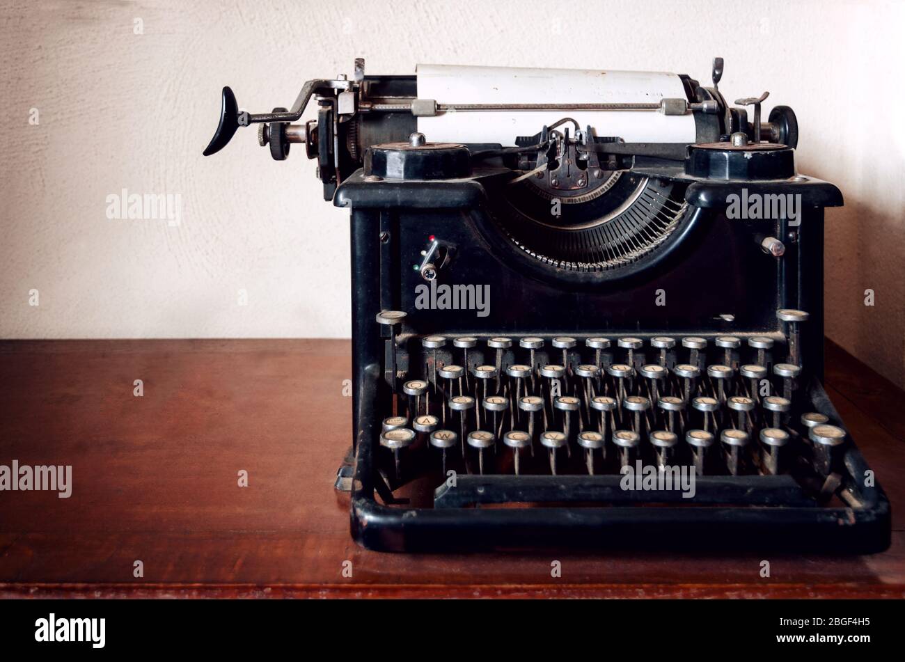 old mechanical typewriter on a wooden table Stock Photo