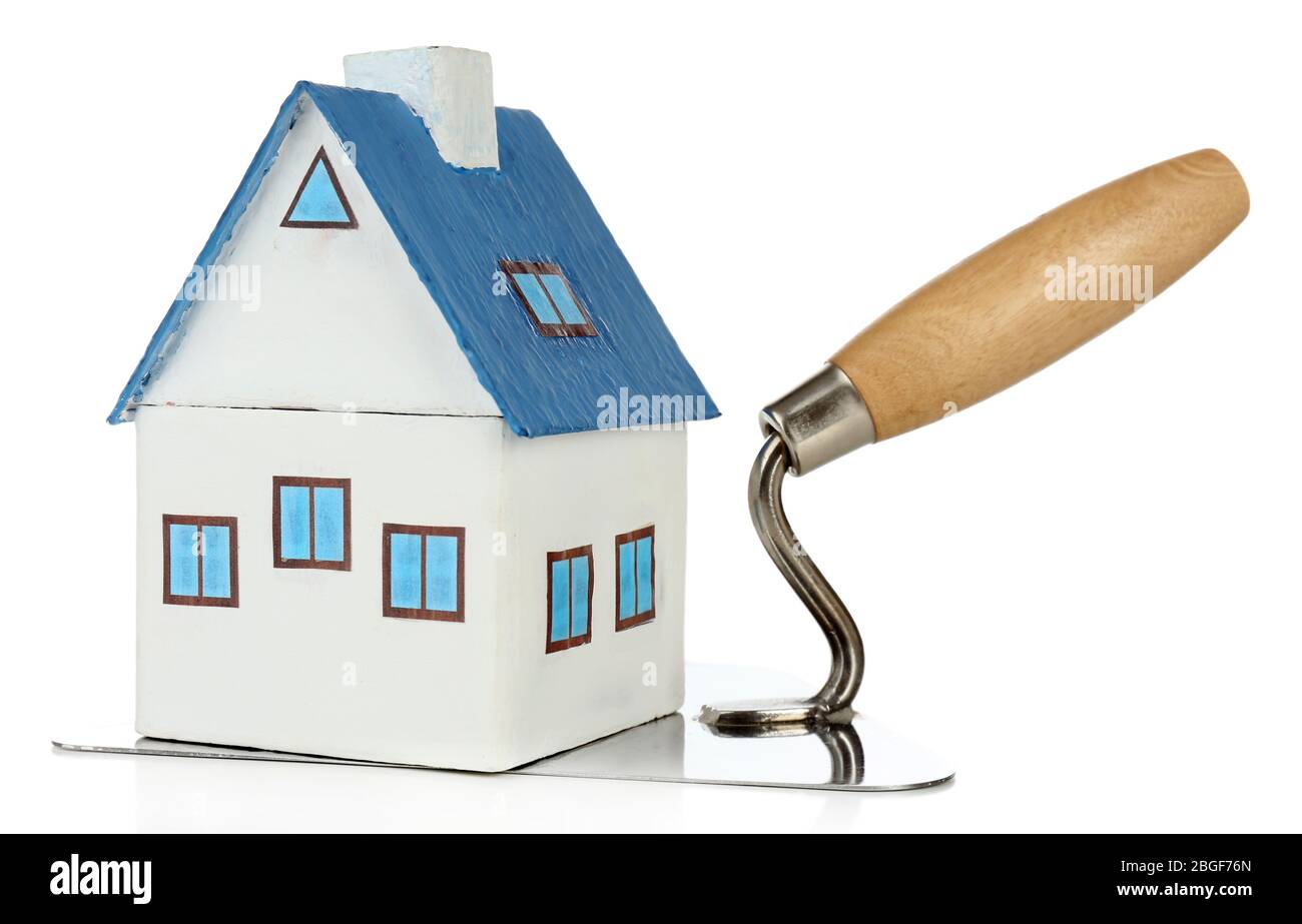 Wooden toy house on trowel and tiles, isolated on white Stock Photo - Alamy