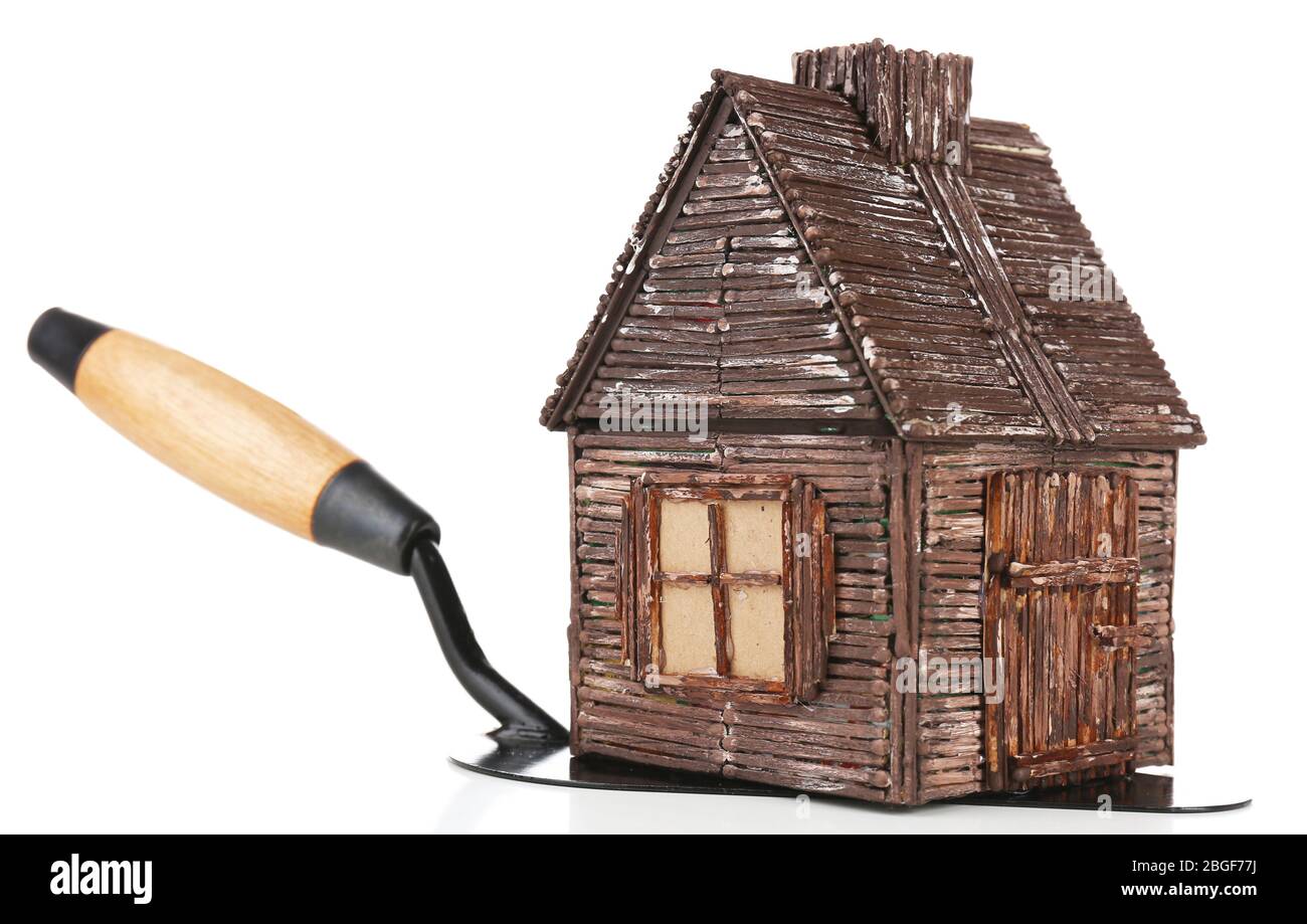 Wooden toy house on trowel and tiles, isolated on white Stock Photo - Alamy