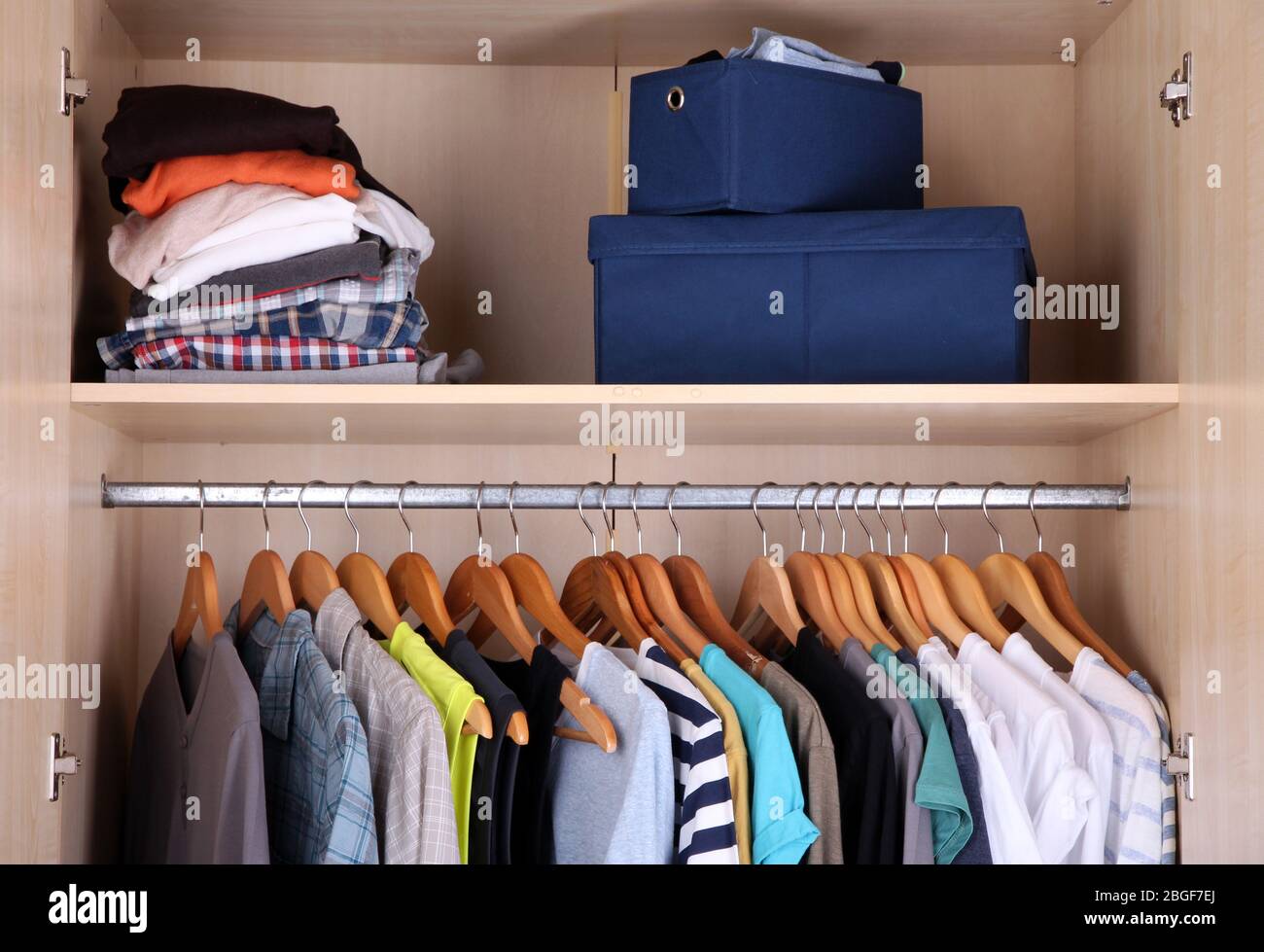 Colorful clothes hanging in wardrobe Stock Photo Alamy