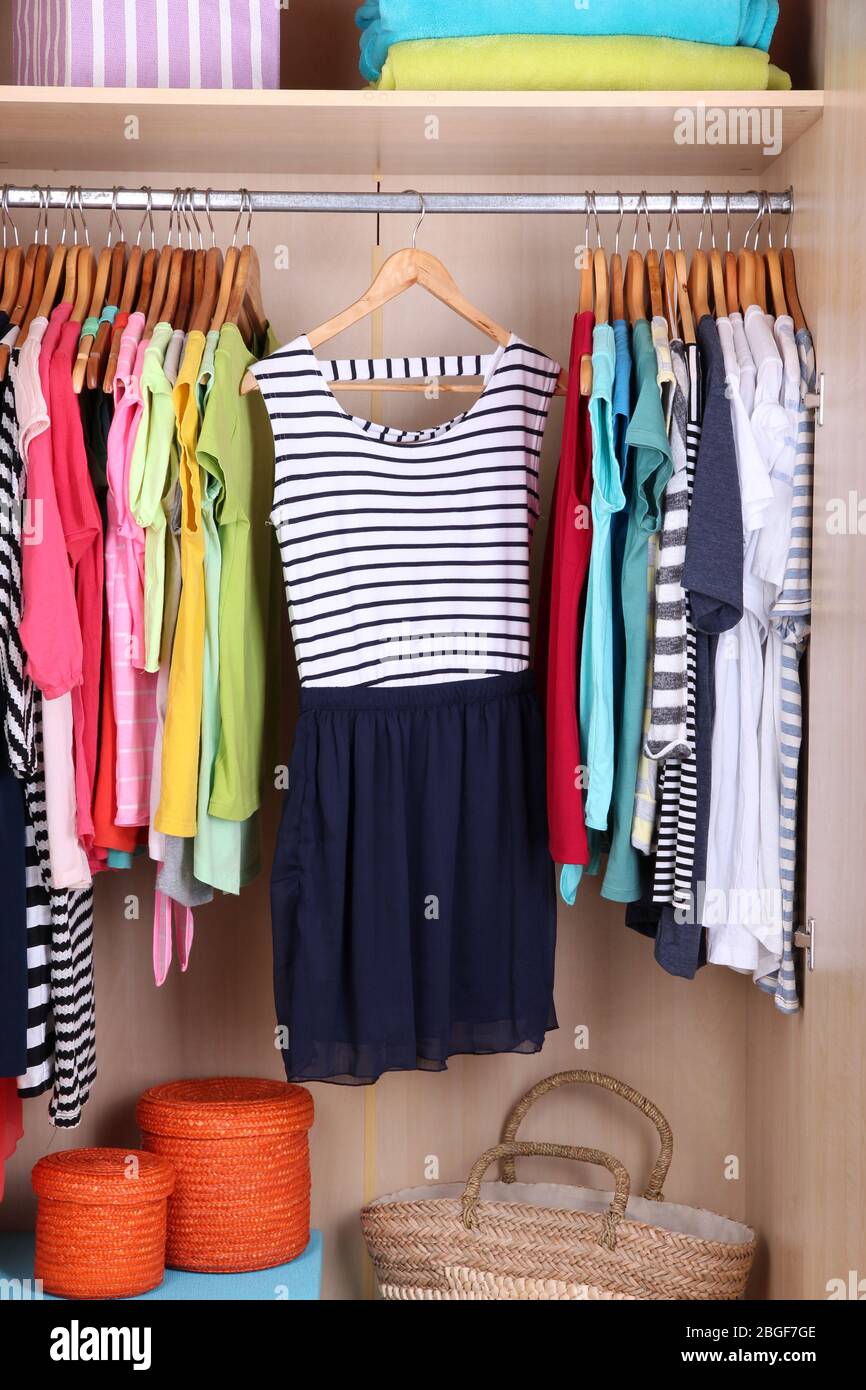 Colorful clothes hanging in wardrobe Stock Photo Alamy