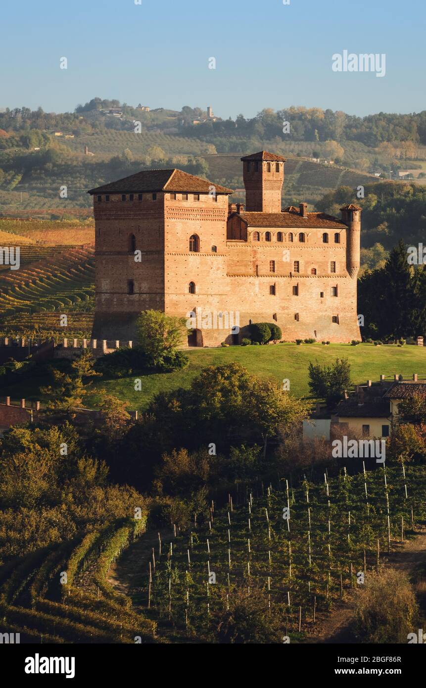 Sunset in autumn, during harvest time, at the castle of Grinzane Cavour, surrounded by the vineyards of Langhe, wine district of Italy Stock Photo