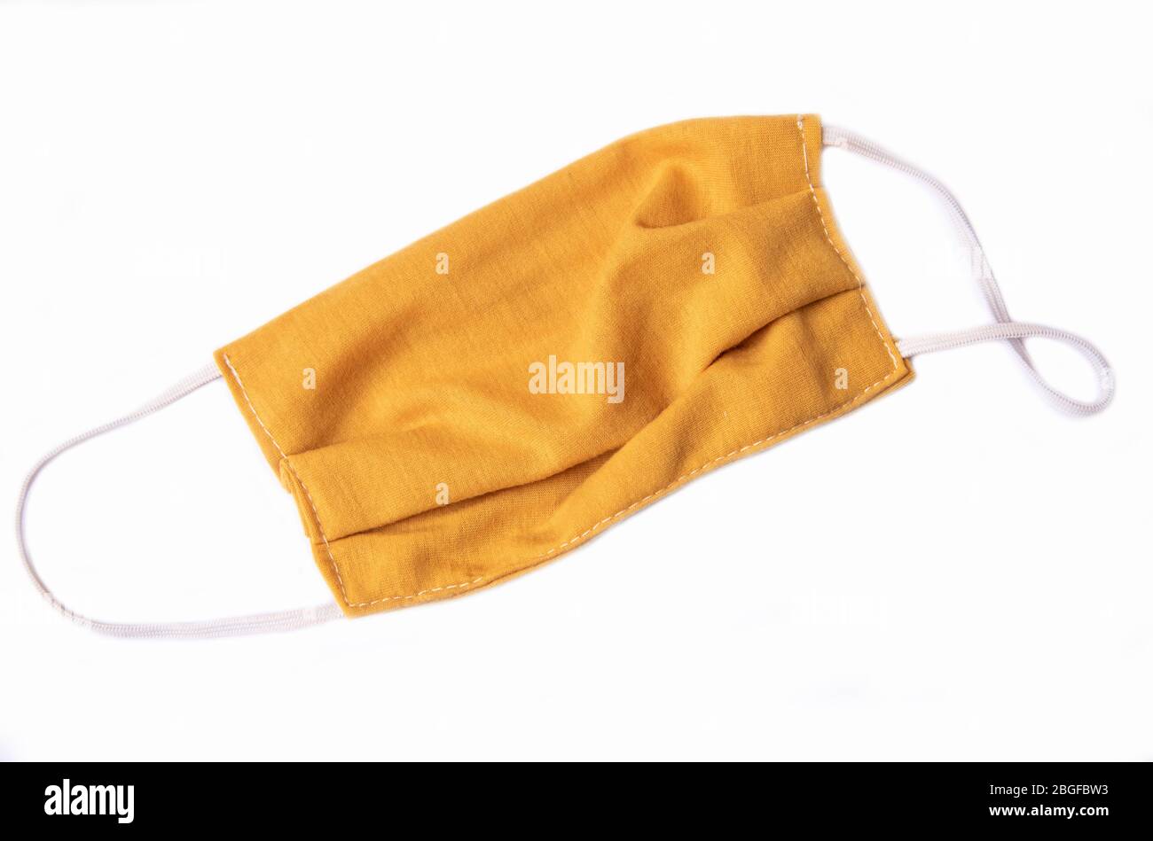 yellow  mask for protection from corona virus on white background Stock Photo