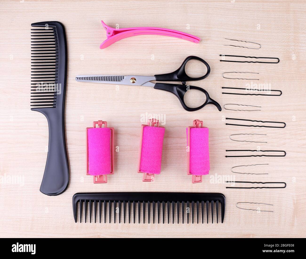 Professional hairdresser tools comb, scissors and pins on light