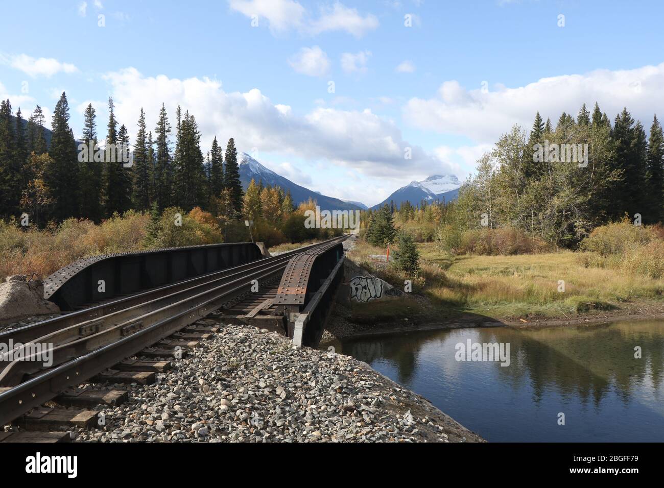 A railroad track crossing a bridge in Banff National Park near downtown Banff, Canada Stock Photo