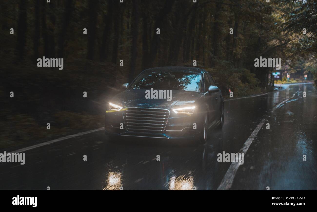 Driving a car in the rainy road with white xenon lights on, in the dark