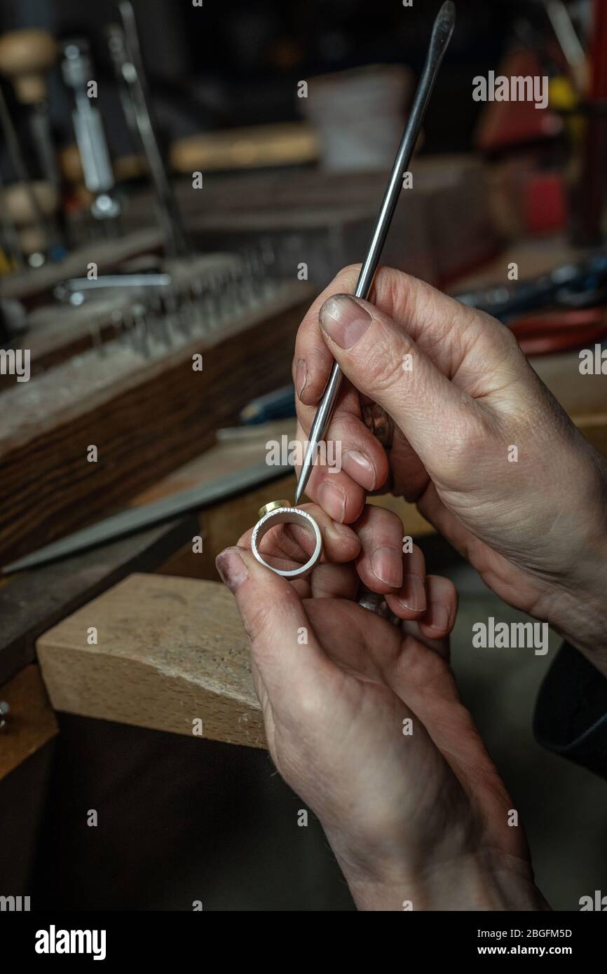 A goldsmith at work in the studio. Stock Photo