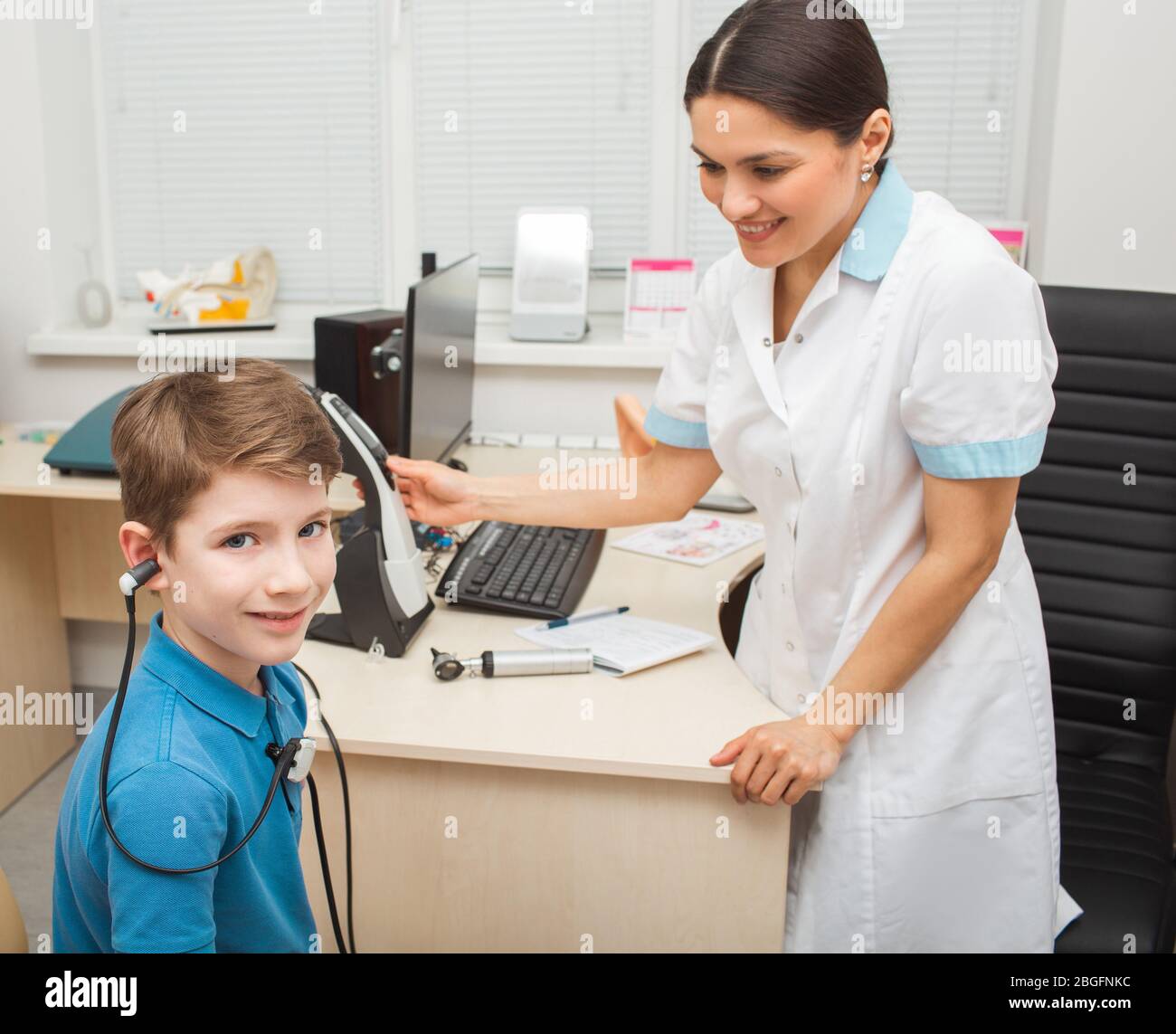 Female otolaryngologist doing a hearing test in a boy. Tympanometry