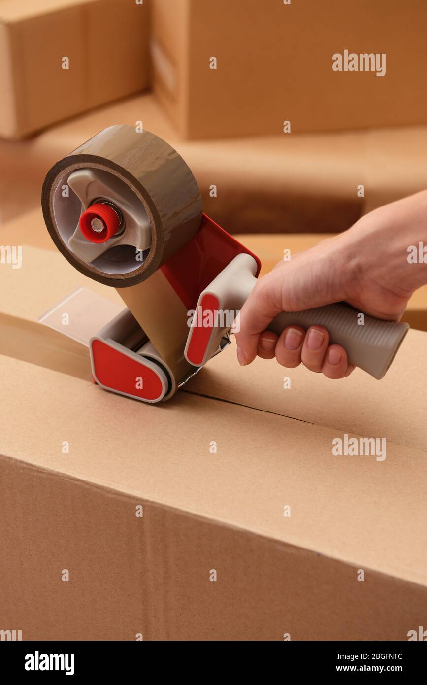 Packaging parcels with dispenser close-up Stock Photo