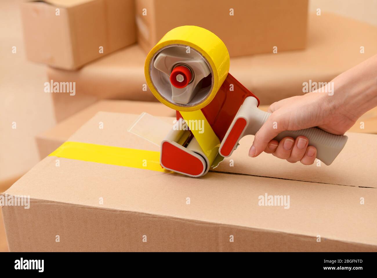 Packaging parcels with dispenser close-up Stock Photo