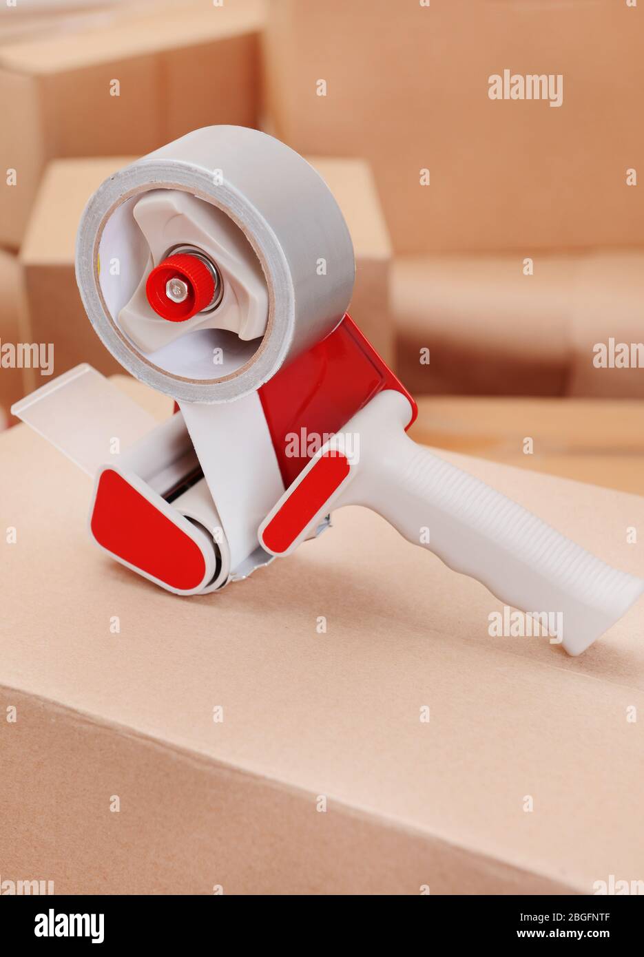 Packaging parcels with dispenser close-up Stock Photo