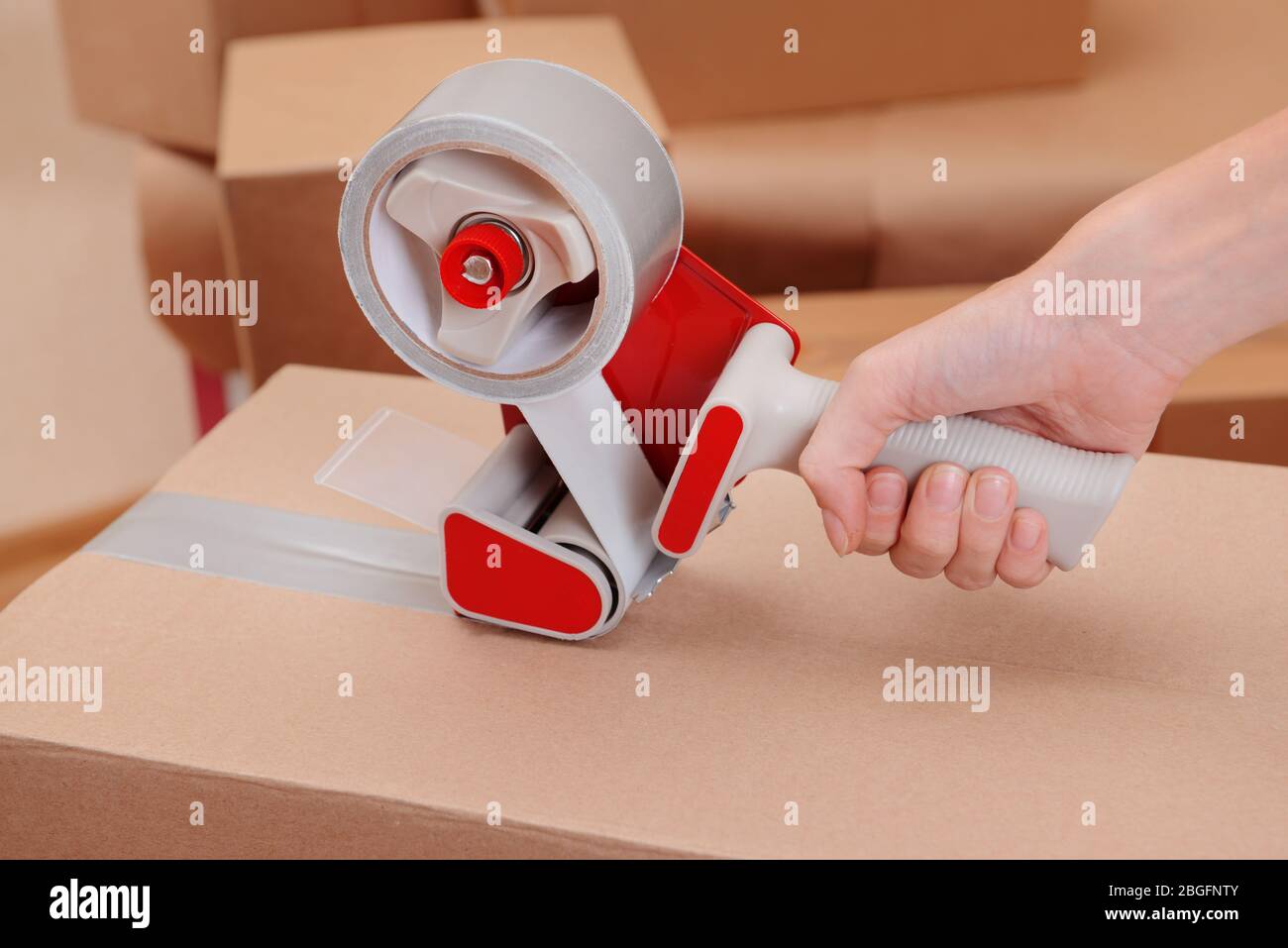 Packaging parcels with dispenser close-up Stock Photo