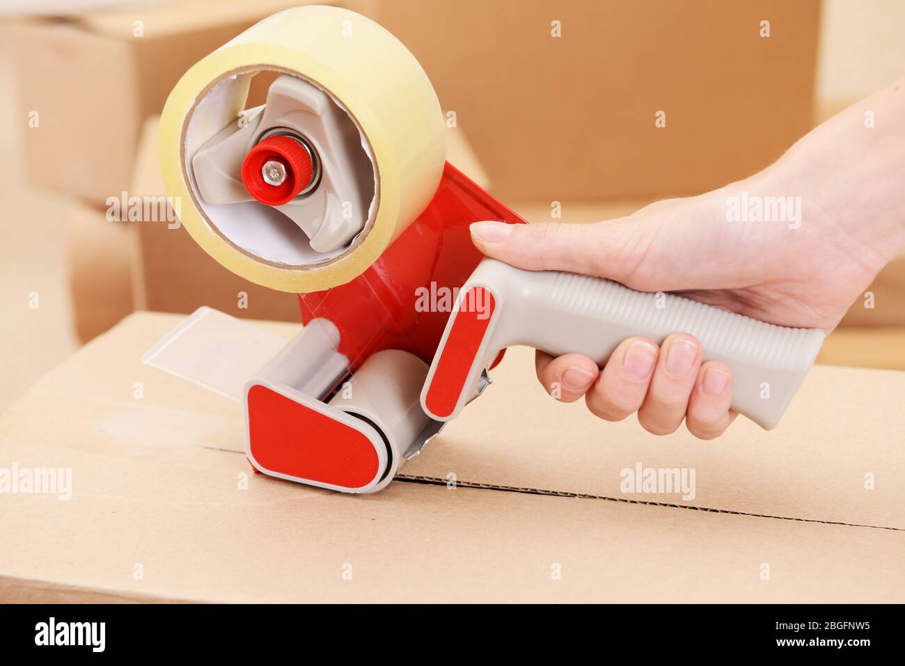 Packaging parcels with dispenser close-up Stock Photo