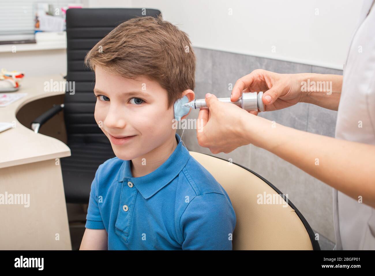 Process of making a custom earplug for a boy. Stages of manufacturing earplugs. Doctor makes