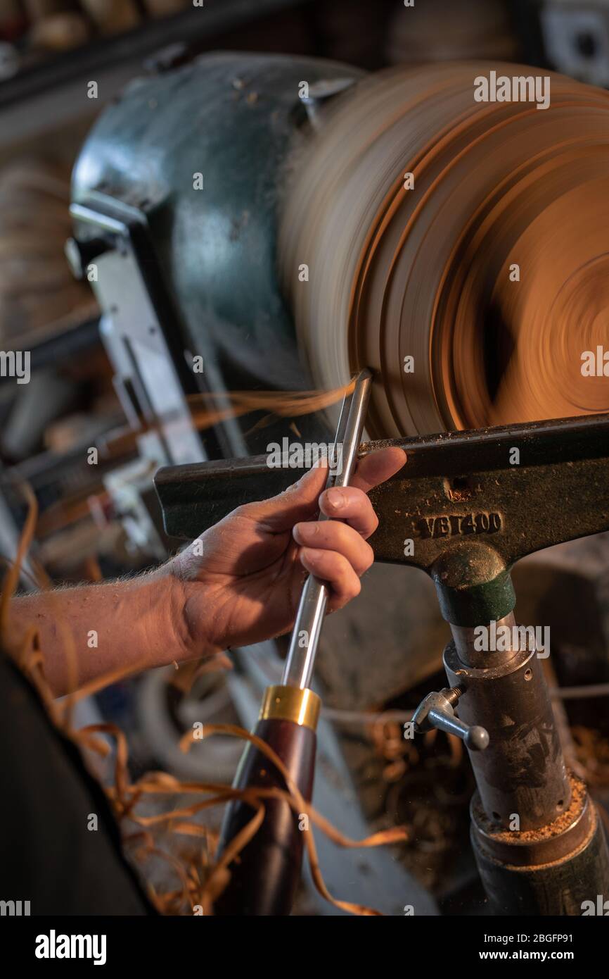 A wood turner working at a lathe. Stock Photo