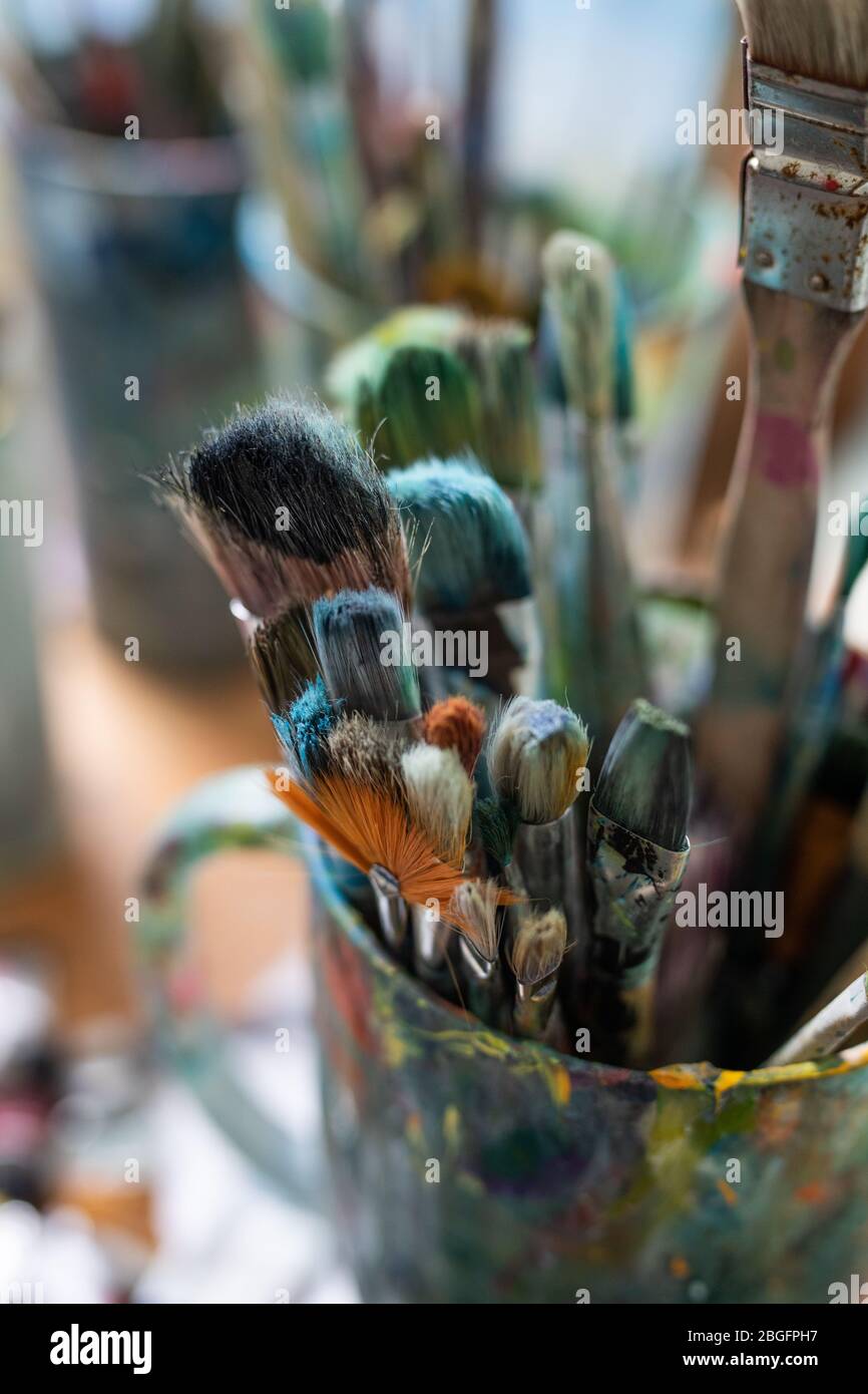 Paint brushes in an artist studio. Stock Photo