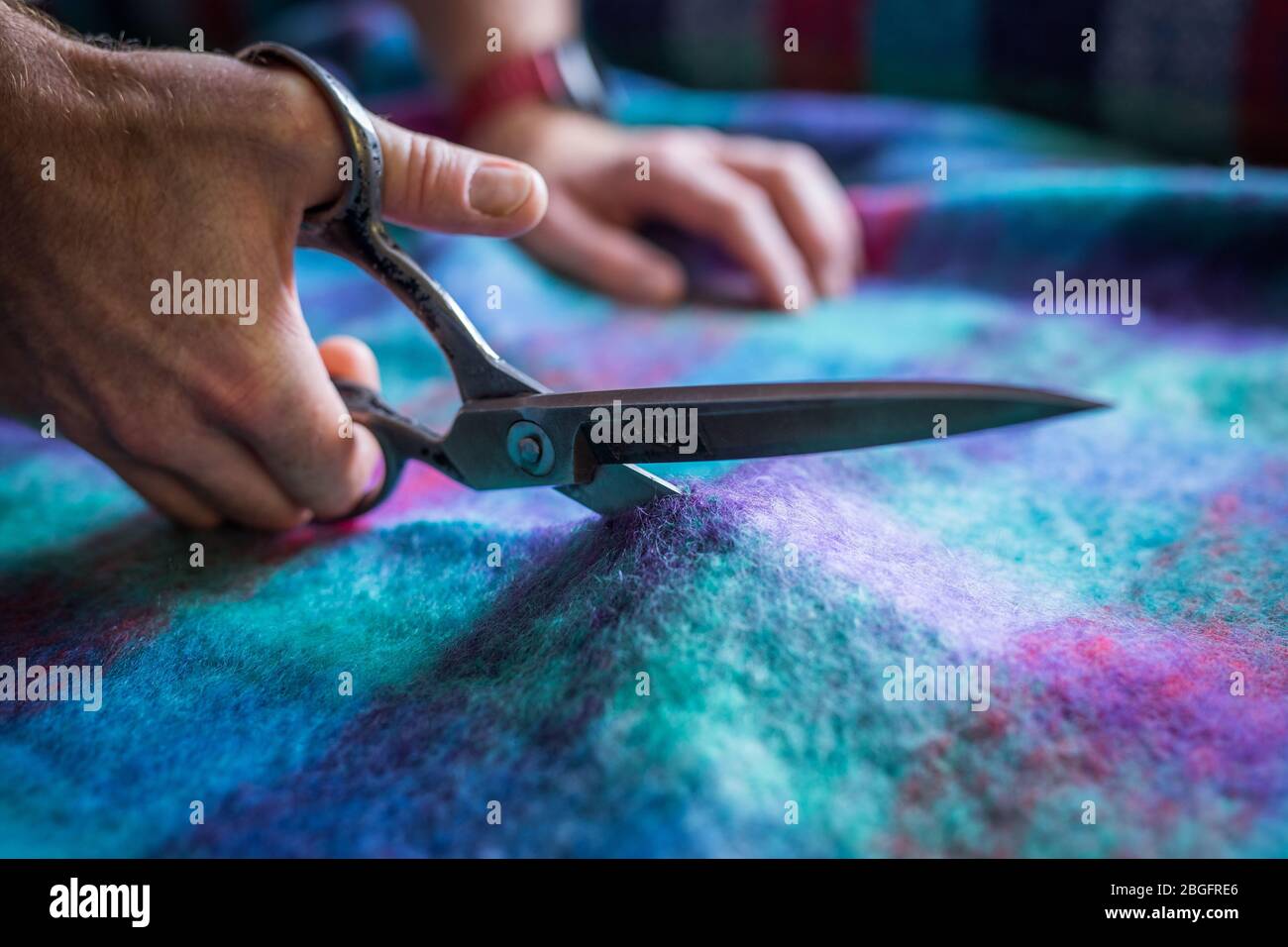 Cutting fabric in a textile factory. Stock Photo