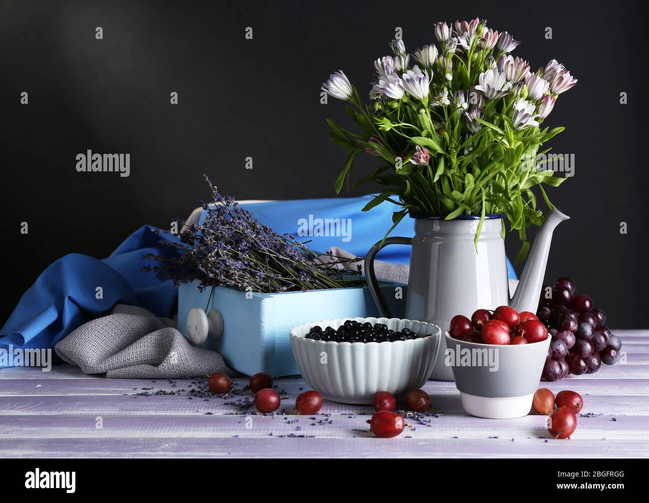 Still life with flowers and fruits on dark background Stock Photo - Alamy
