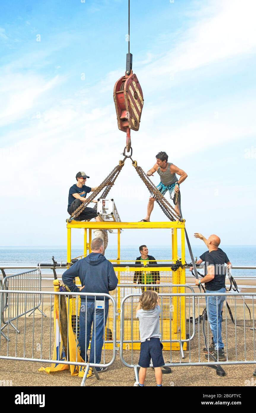 Group of men preparing cage for base jumpers Stock Photo