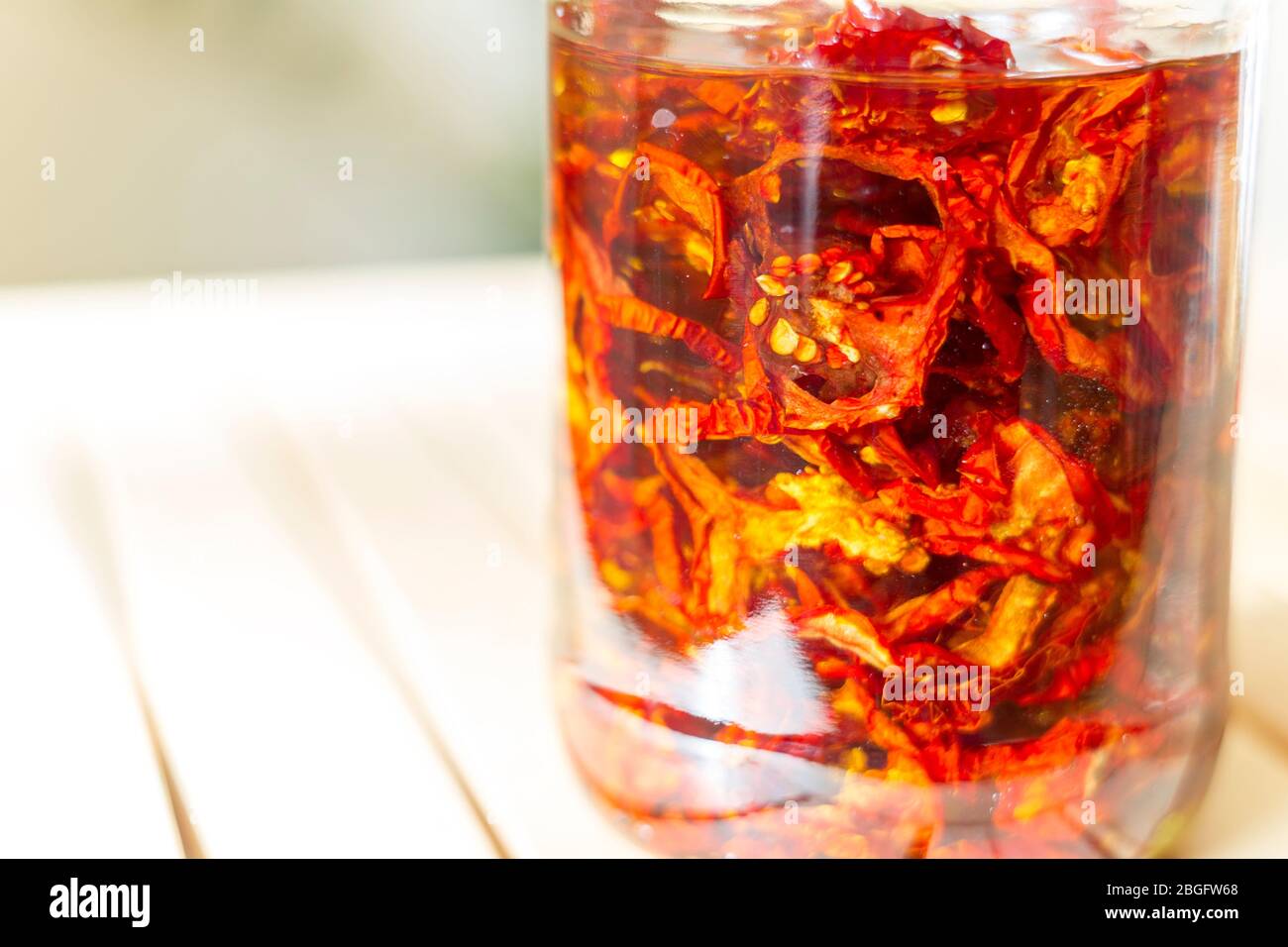 Sun dried red tomatoes in jar with olive oil. Stock Photo