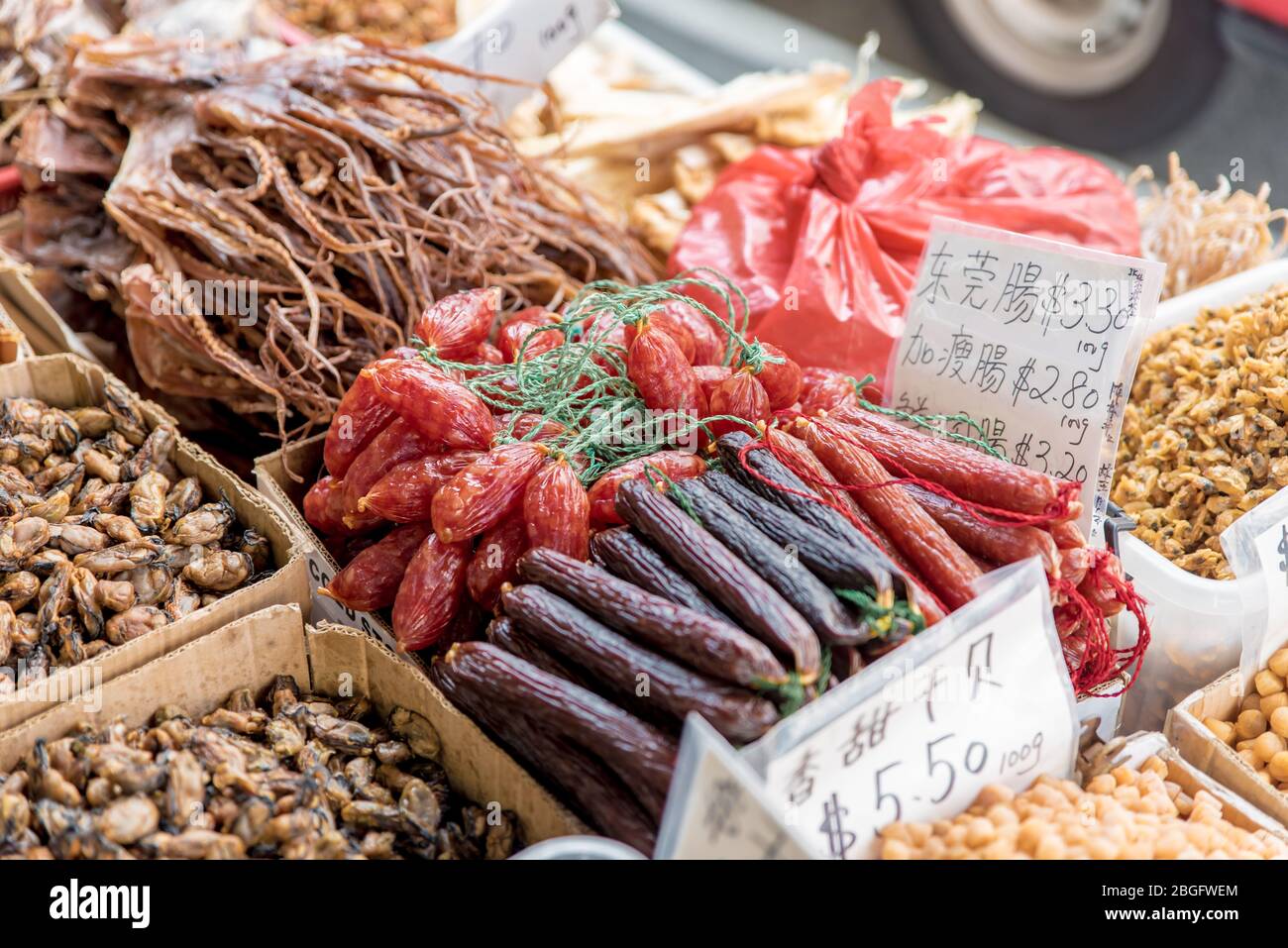 Dried squid skin for sale in basket with price tag. Oriental, crispy