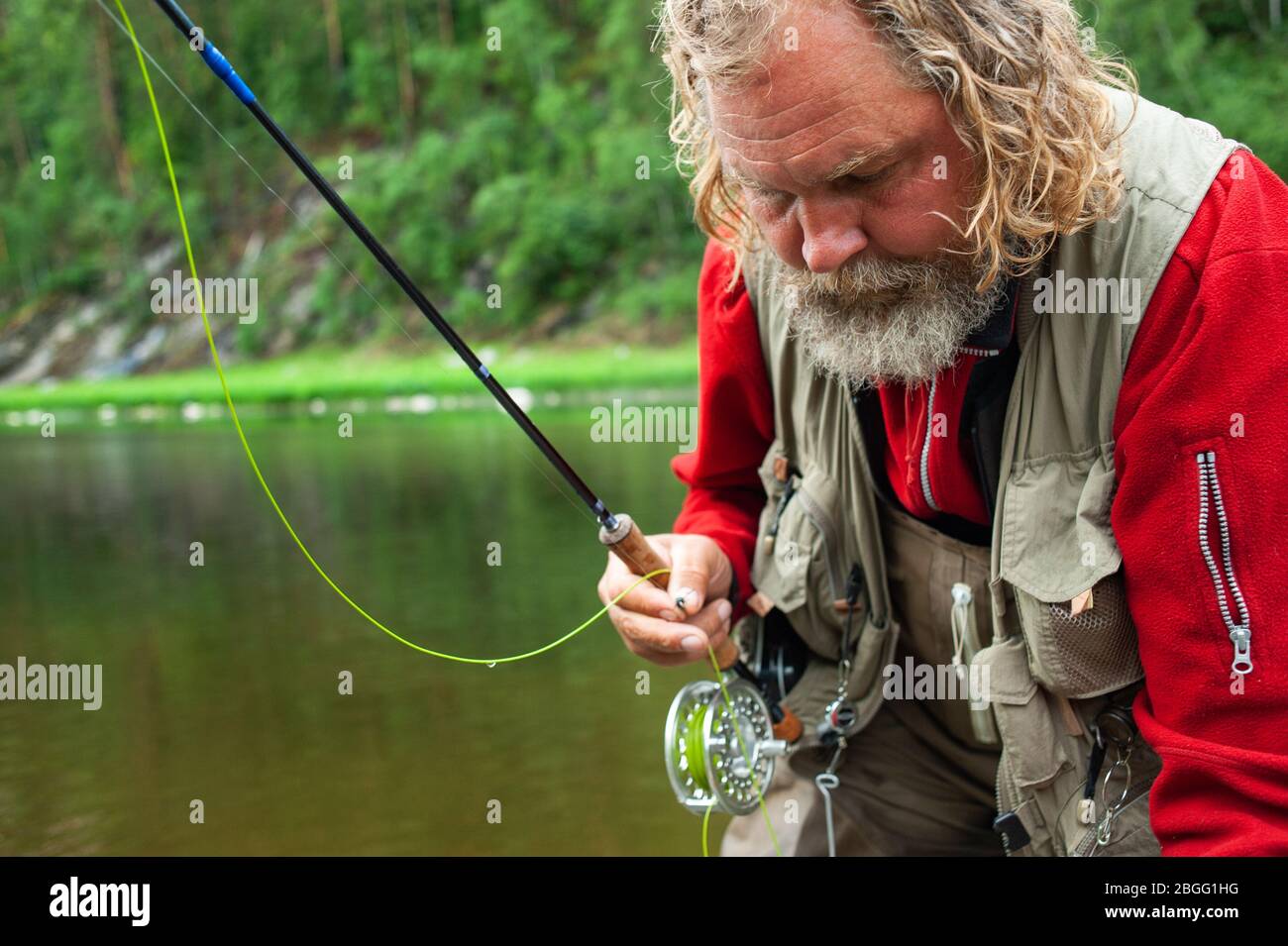 fly fishing angler makes cast while standing in water Stock Photo Alamy